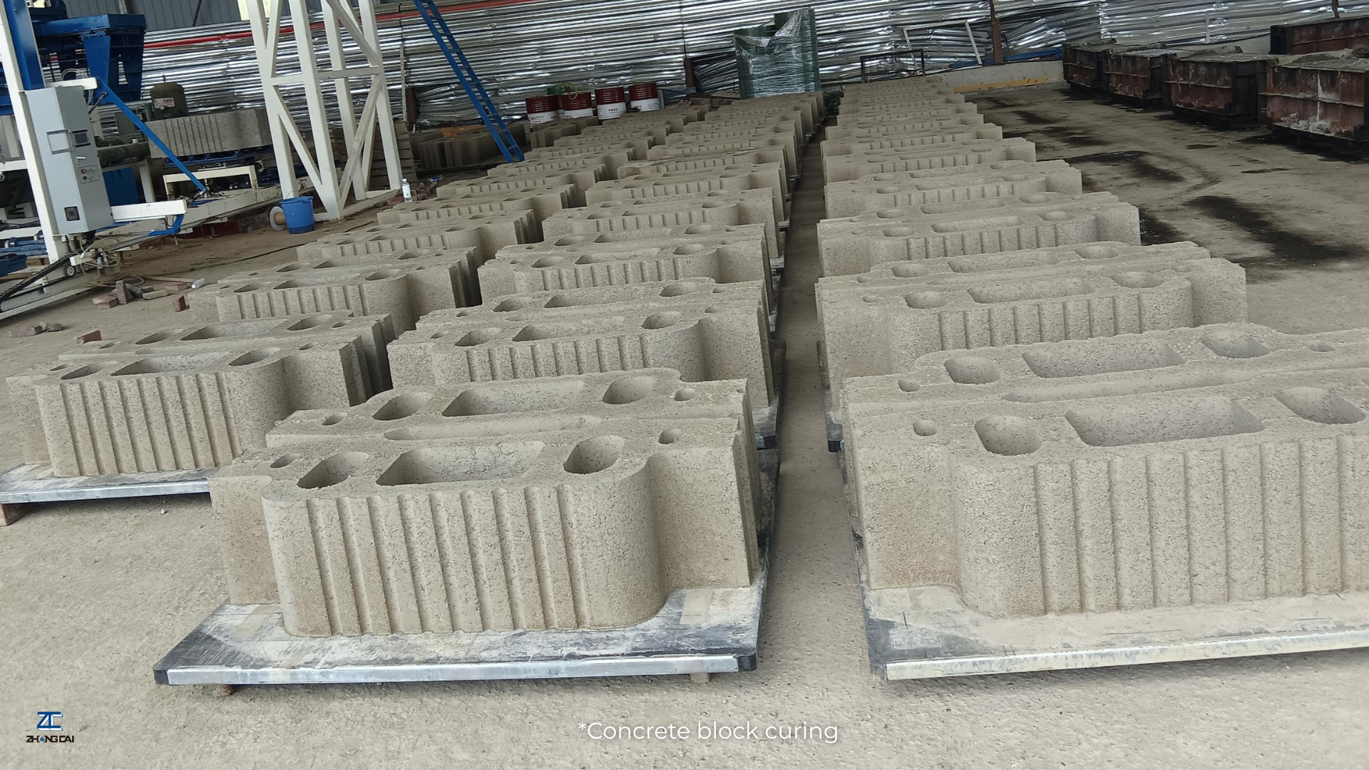 Concrete block curing racks arranged for organized pallet storage and handling access..png